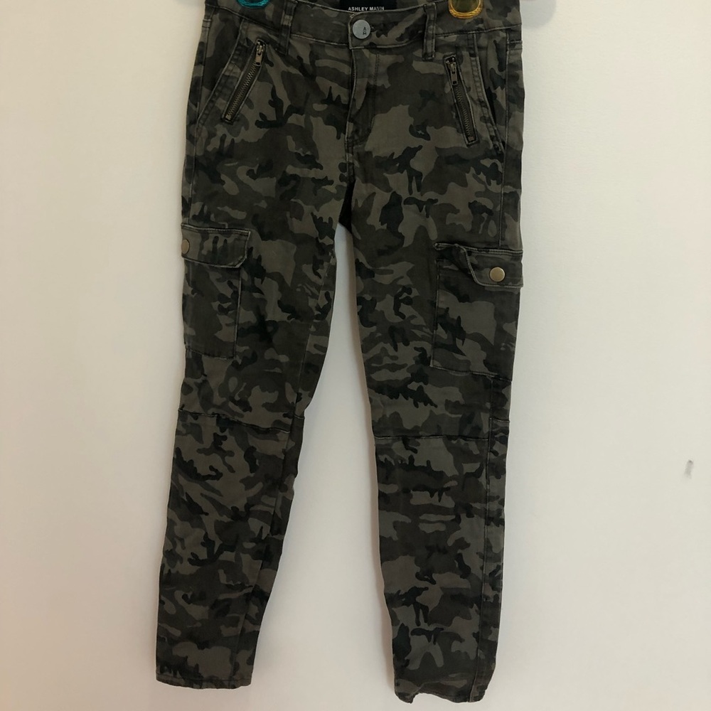 Small, skinny, green camouflage jeans.